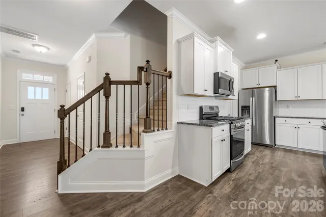 a kitchen with white cabinets and white appliances