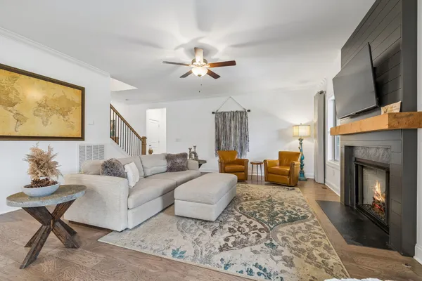 a living room with furniture a fireplace and a flat screen tv