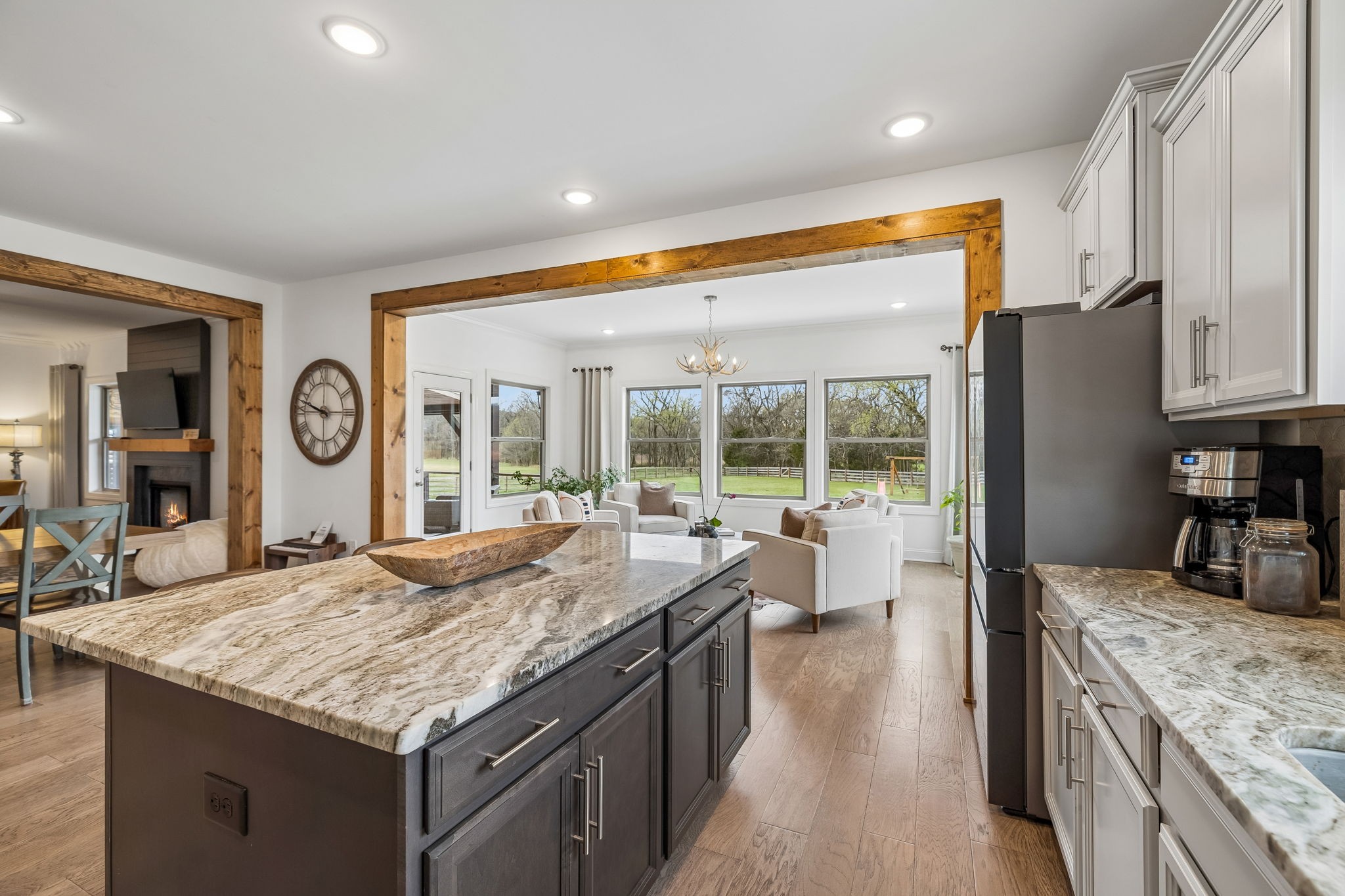 12745 North Milton Road Milton, TN 37118 - Photo 22 of 57 a kitchen with granite countertop center island wooden floor and stainless steel appliances