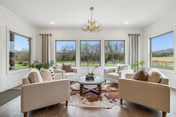 a living room with furniture and kitchen view