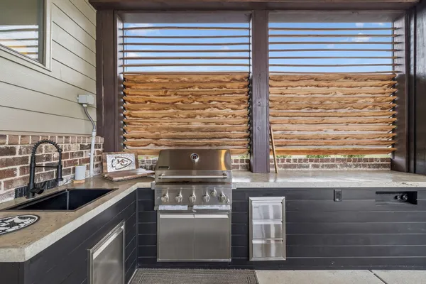 a kitchen with stainless steel appliances a refrigerator and cabinets