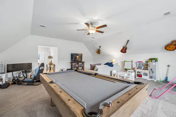 a bathroom with a sink a toilet and shower curtain