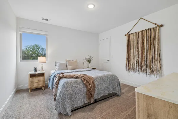 a bedroom with a bed and a window