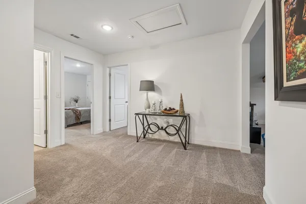 a view of a house with a yard and a large tree