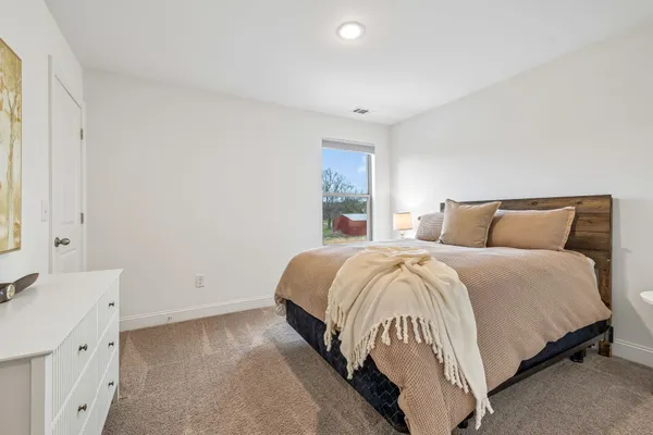 a view of swimming pool with lawn chairs and large trees