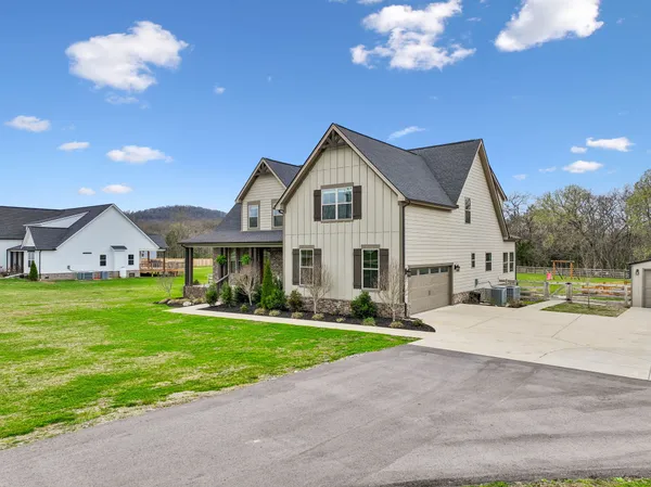 a front view of a house with a yard and garage