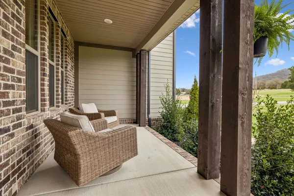 a balcony with furniture and a potted plant