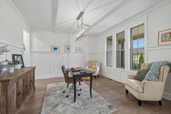 a living room with furniture and a chandelier