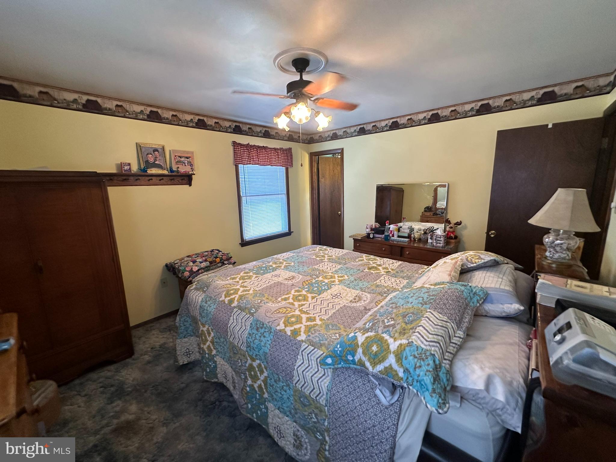 4829 Lehman Road Spring Grove, PA 17362 - Photo 16 of 42 a bedroom with a bed ceiling fan and a wooden floor