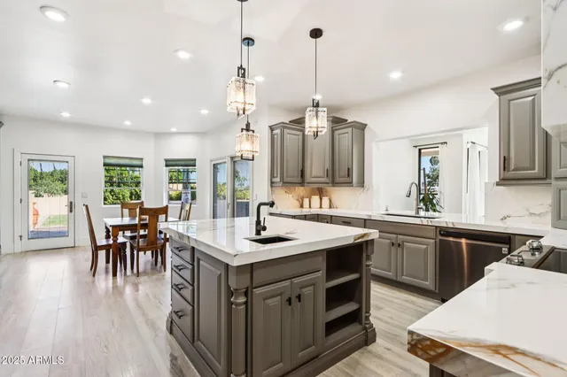 a bed sitting in a bedroom next to a lamp and a potted plant