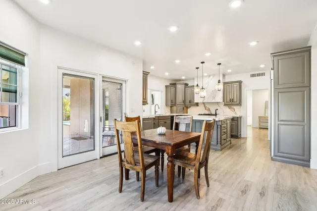 a dining room with furniture wooden floor and a window