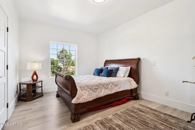 a view of a house with a big yard and a large tree