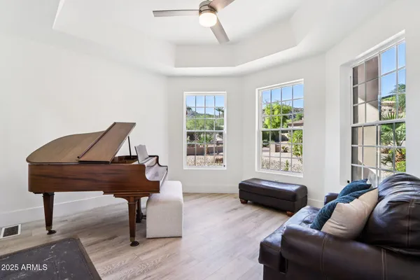 a view of a dining room and livingroom with furniture wooden floor a chandelier