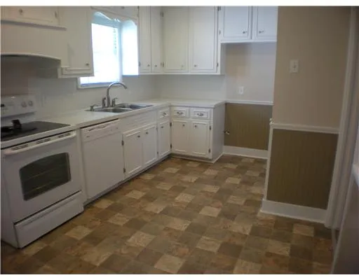 a kitchen with sink cabinets and window