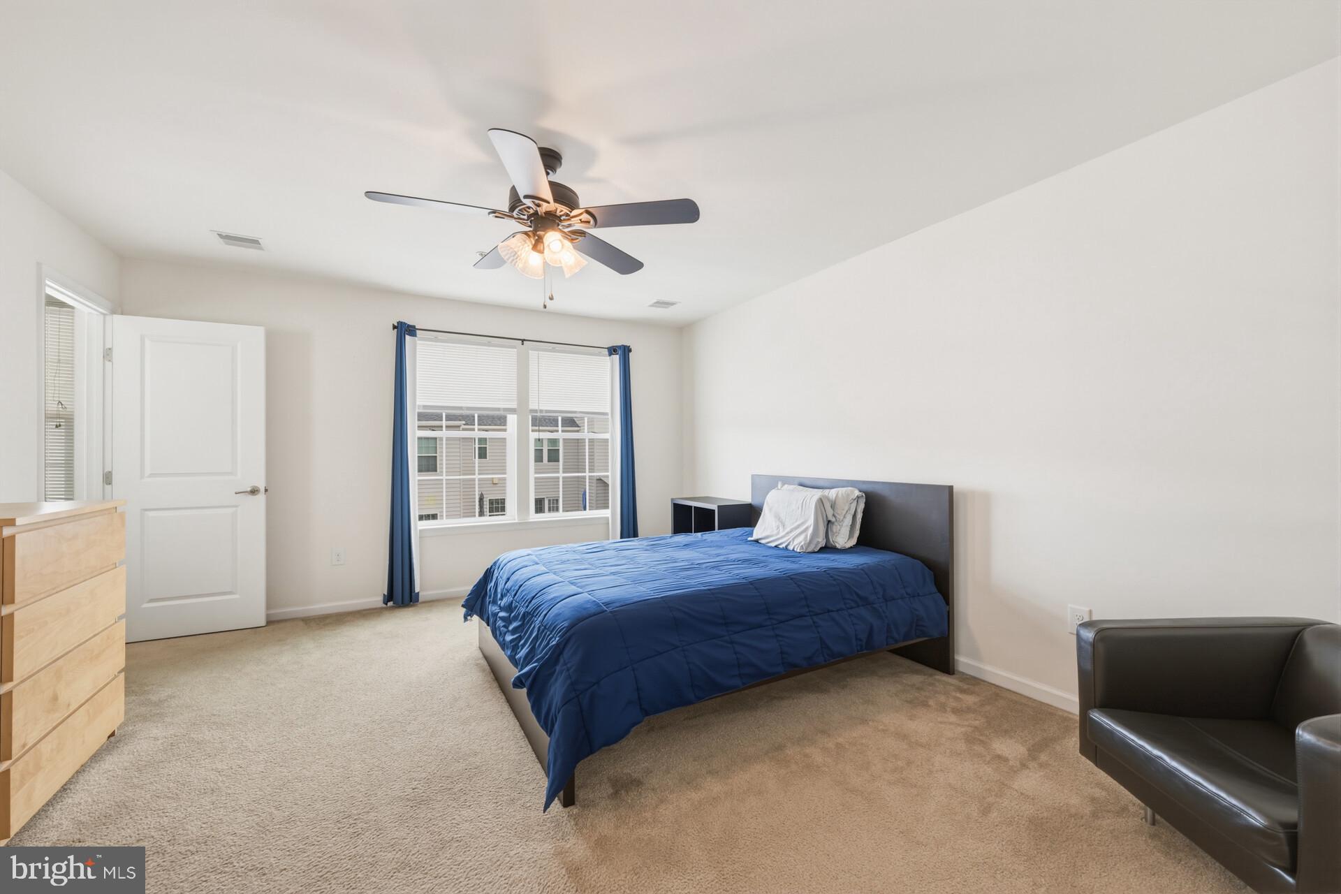 325 Schmidt Road Phoenixville, PA 19460 - Photo 23 of 27 a bedroom with a large bed chandelier and a window