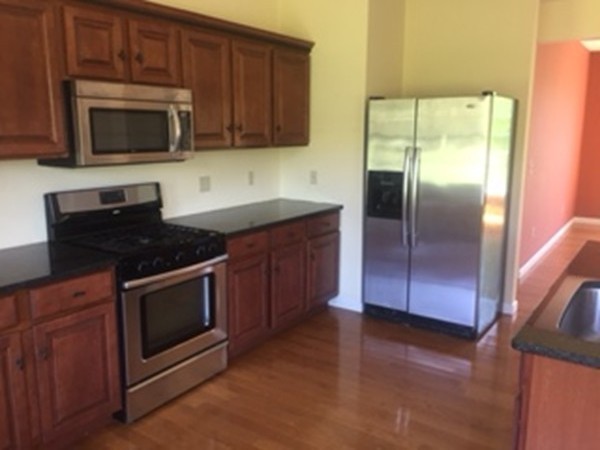 10 Gunn Road Montague, MA 01351 - Photo 12 of 26 a kitchen with granite countertop a refrigerator stove and microwave