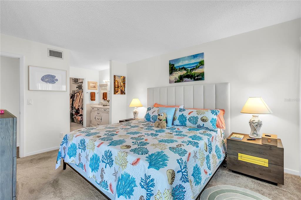 12200 Vonn Road, Unit 2206 Largo, FL 33774 - Photo 29 of 60 a bedroom with a bed and a lamp
