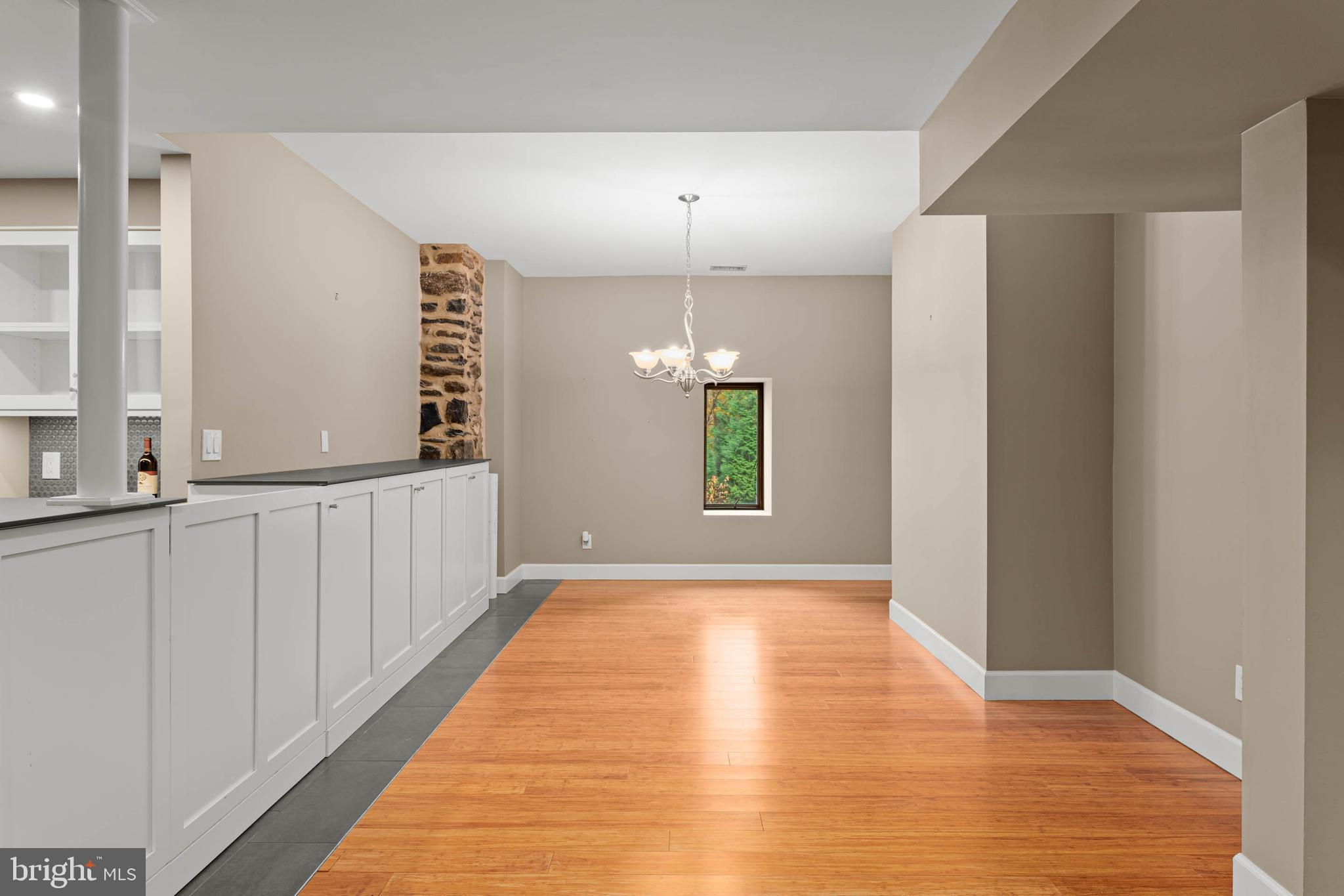 1311 Hagys Ford Road Penn Valley, PA 19072 - Photo 14 of 80 a view of a hallway with wooden floor and a kitchen
