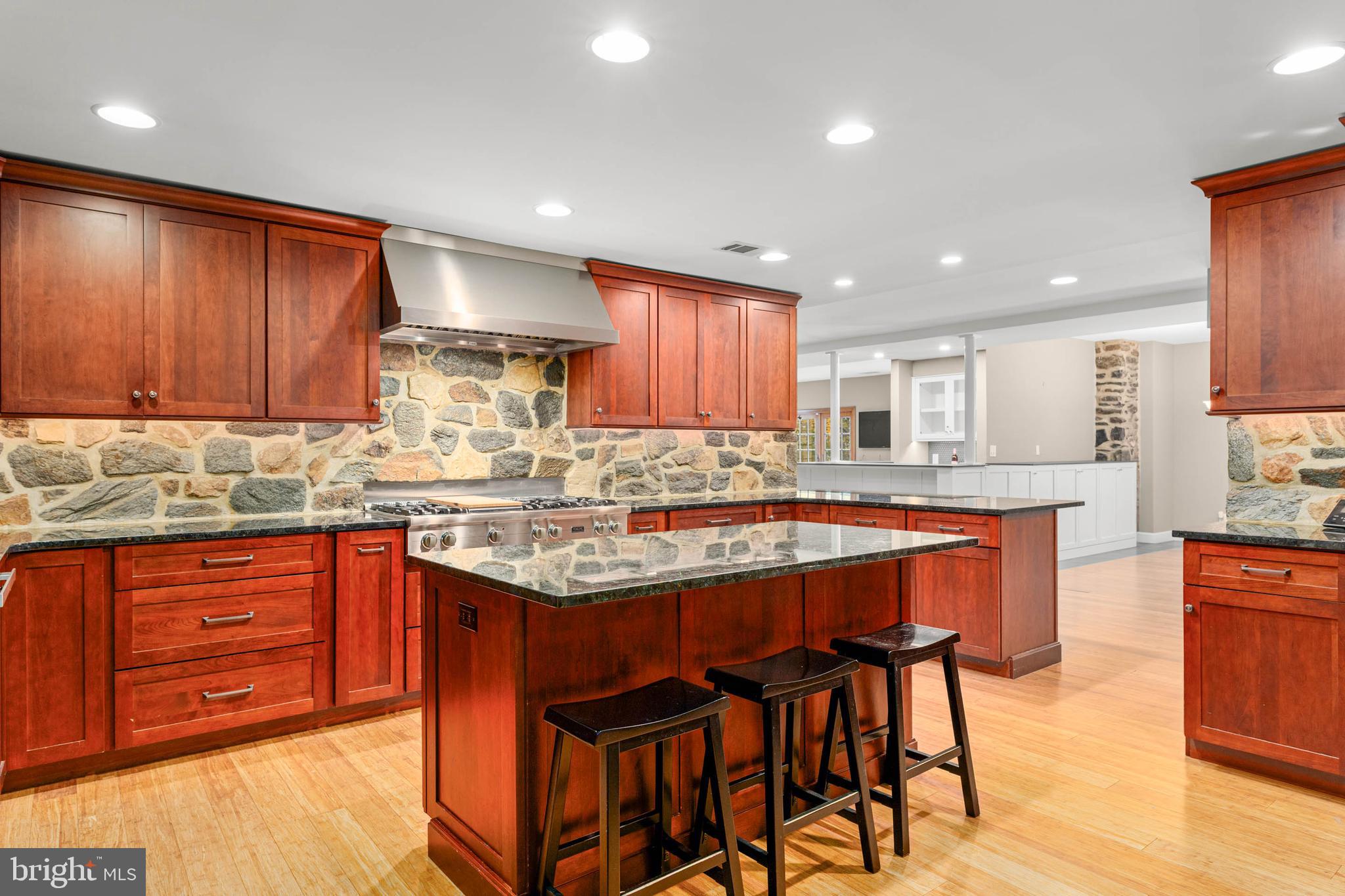 1311 Hagys Ford Road Penn Valley, PA 19072 - Photo 19 of 80 a kitchen with stainless steel appliances granite countertop wooden cabinets a dining table and chairs