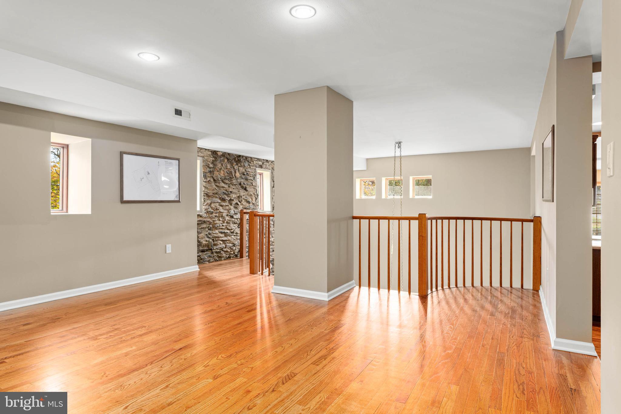 1311 Hagys Ford Road Penn Valley, PA 19072 - Photo 26 of 80 a view of an empty room with wooden floor and a window