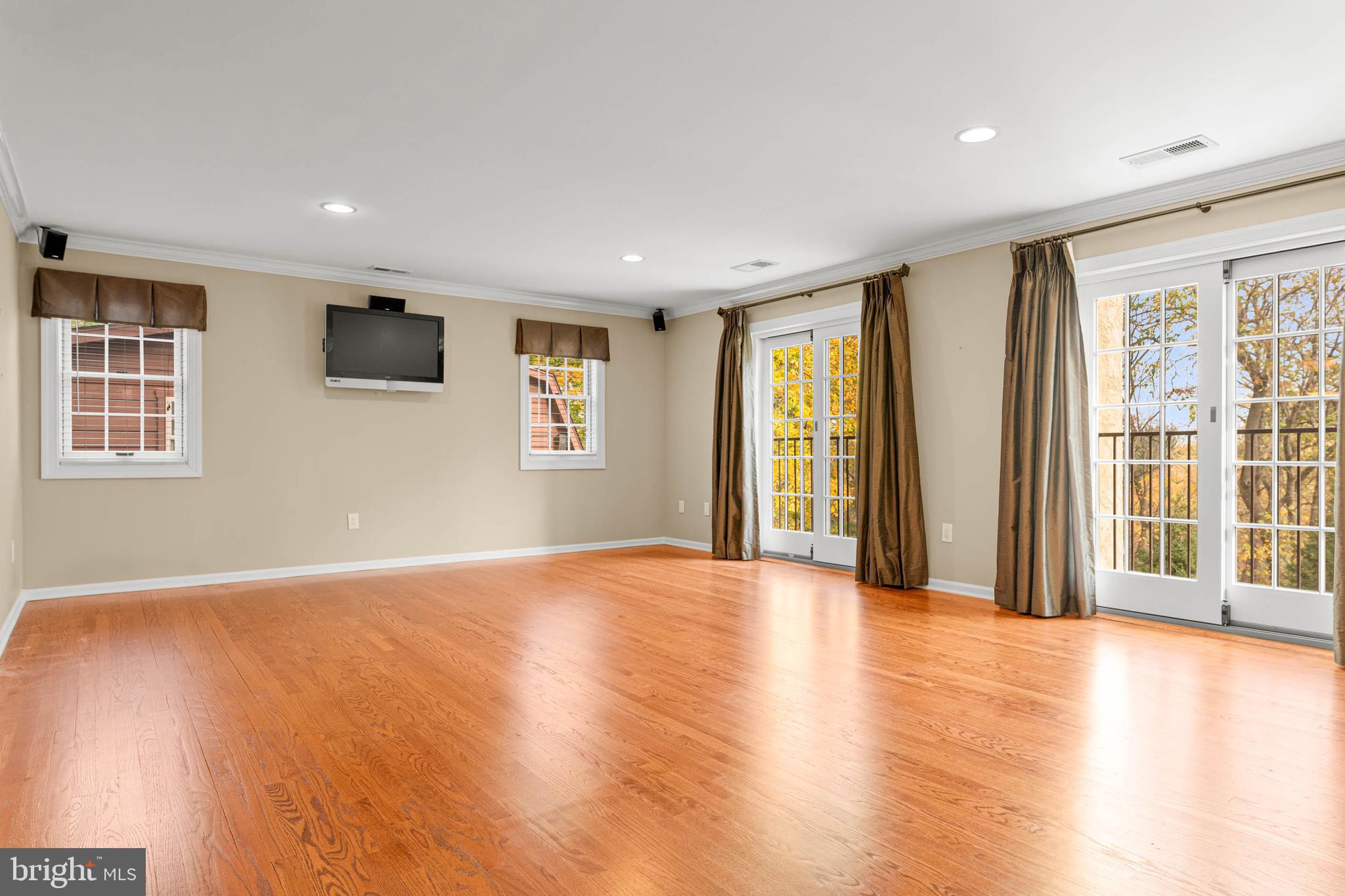 1311 Hagys Ford Road Penn Valley, PA 19072 - Photo 29 of 80 a view of an empty room with a window and wooden floor