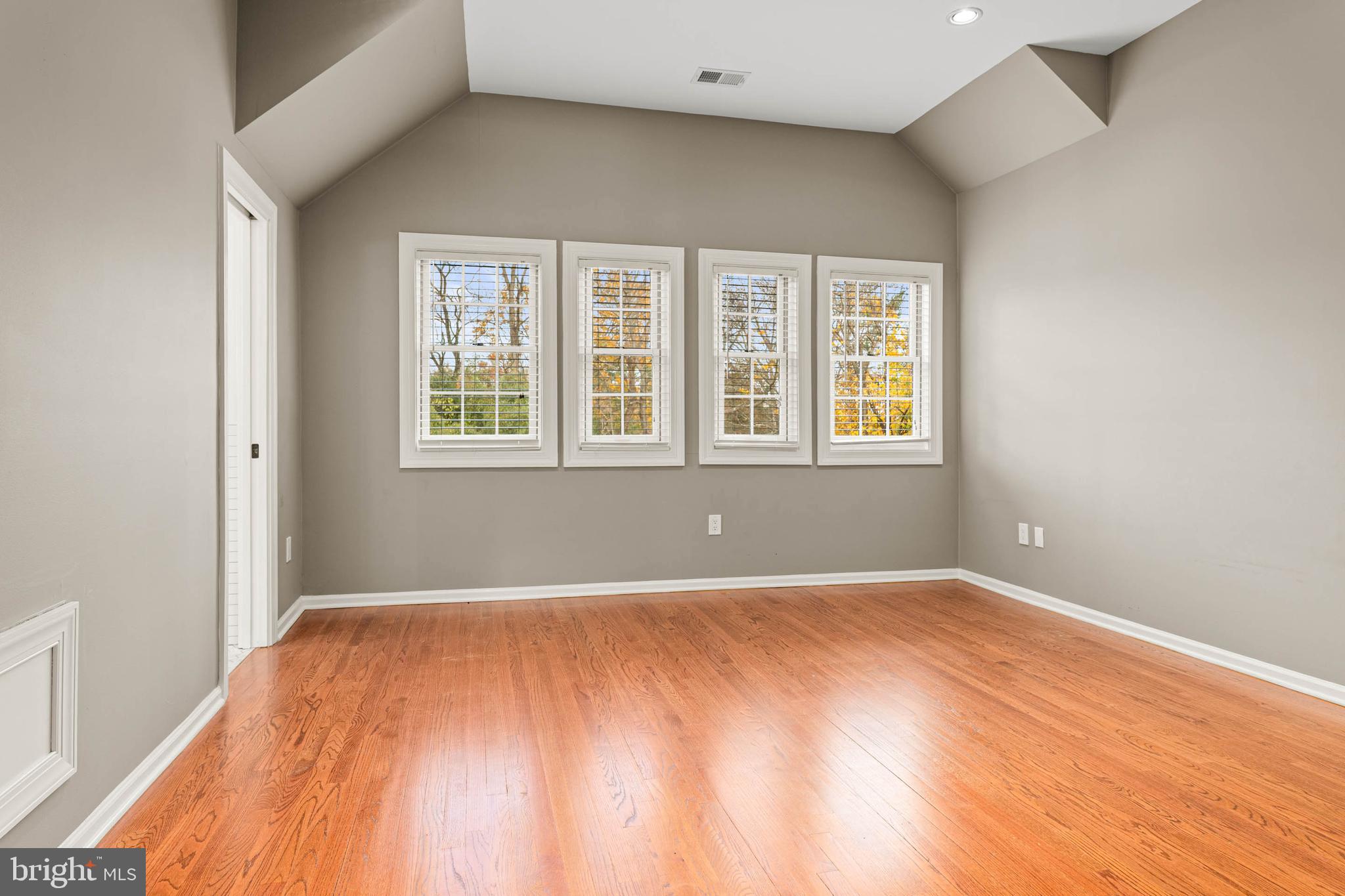 1311 Hagys Ford Road Penn Valley, PA 19072 - Photo 52 of 80 a view of an empty room with a window and wooden floor