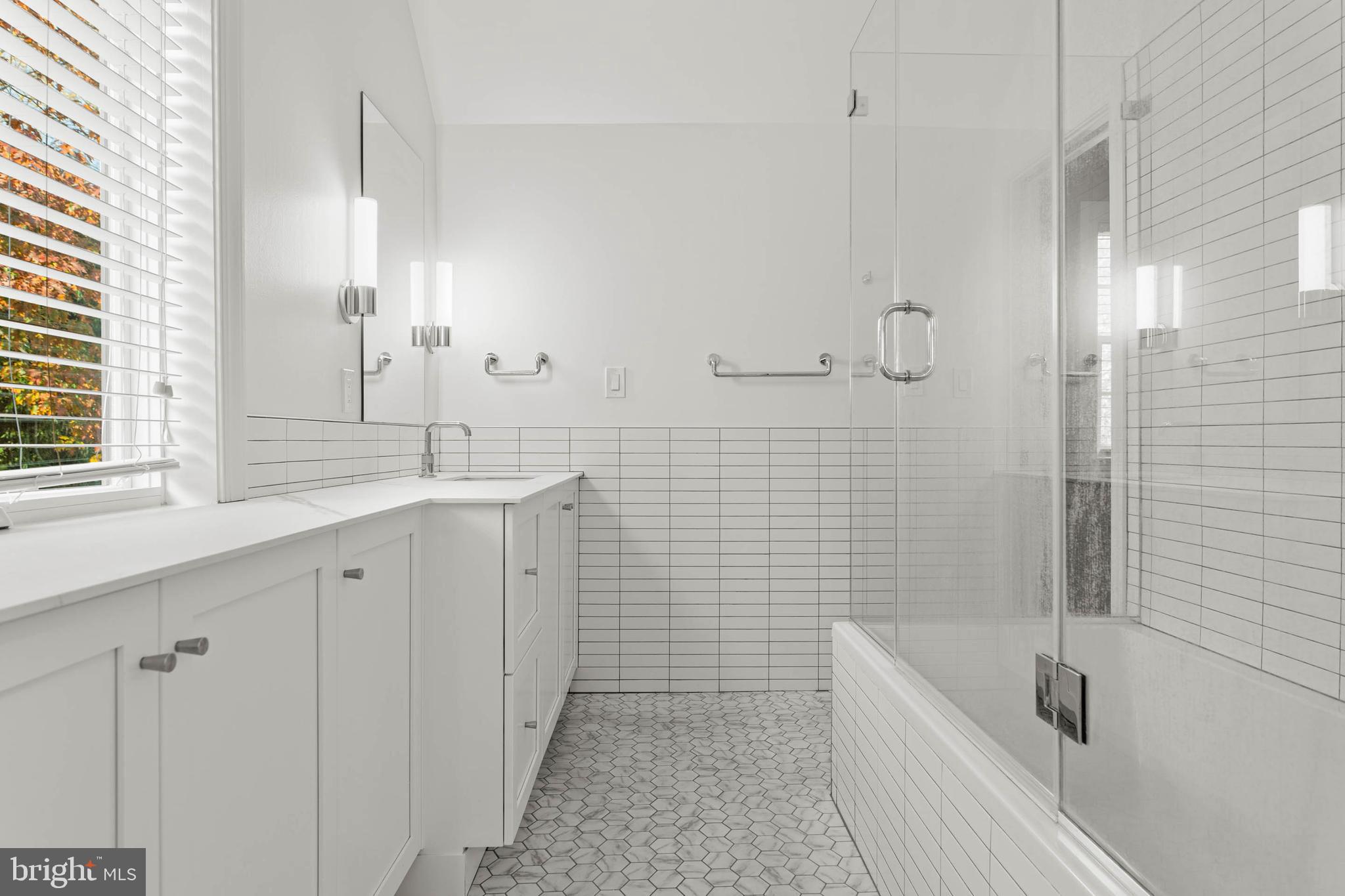 1311 Hagys Ford Road Penn Valley, PA 19072 - Photo 56 of 80 a bathroom with a tub a sink a mirror and a shower