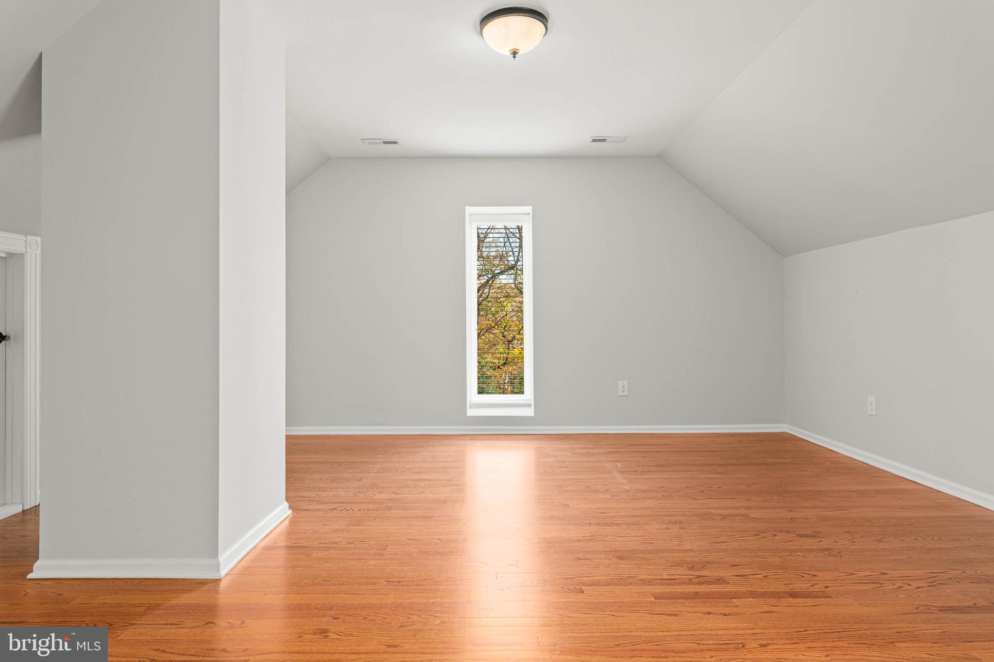 1311 Hagys Ford Road Penn Valley, PA 19072 - Photo 58 of 80 a view of an empty room with wooden floor and a window