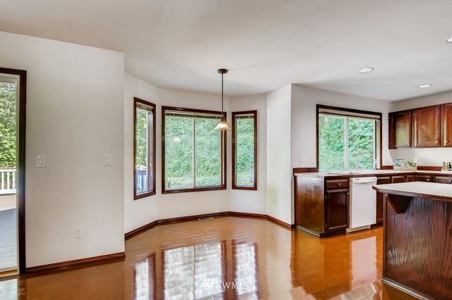 a kitchen with stainless steel appliances granite countertop a stove a refrigerator and a microwave