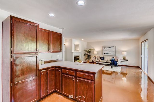 a kitchen with stainless steel appliances granite countertop a refrigerator a sink a stove and island