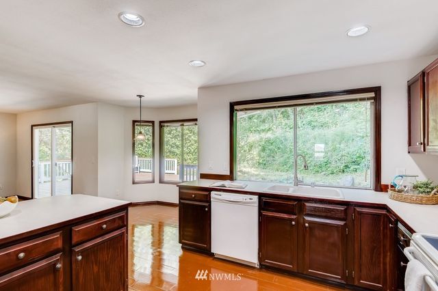 a kitchen with granite countertop a large window and a sink