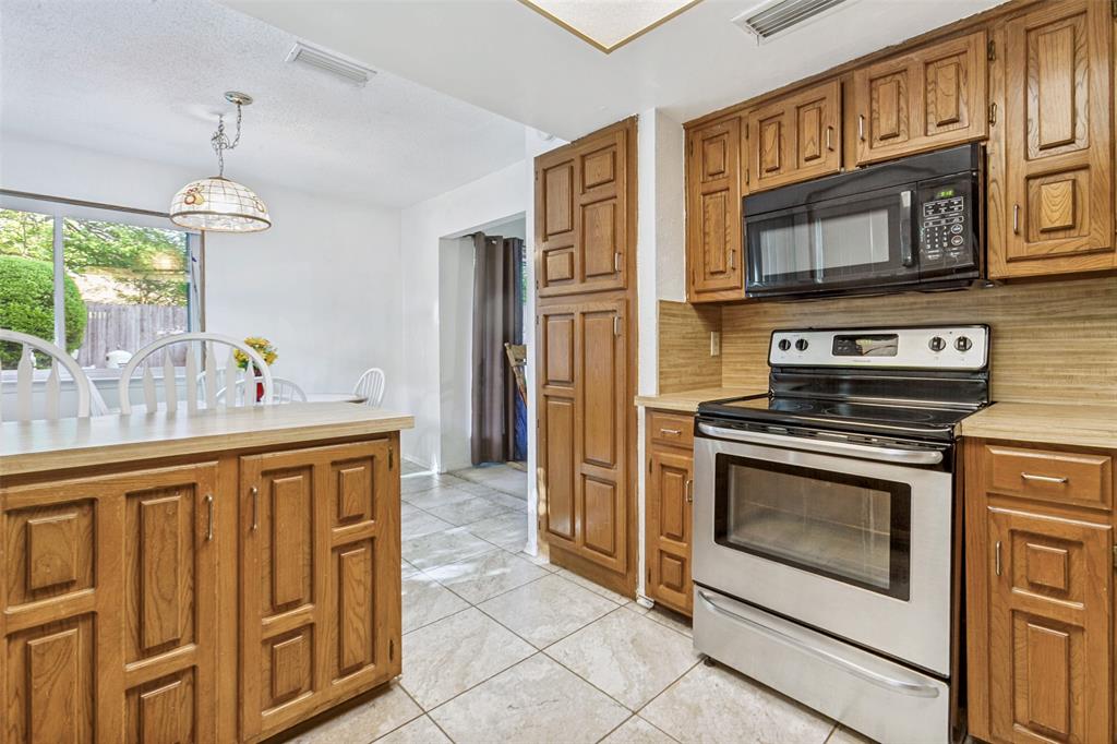 44 Merrie Circle Richardson, TX 75081 - Photo 12 of 30 a kitchen with stainless steel appliances a stove a sink and a refrigerator