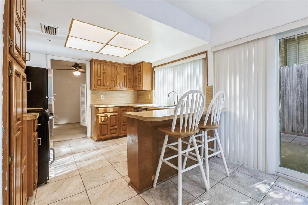 44 Merrie Circle Richardson, TX 75081 - Photo 14 of 30 a kitchen with stainless steel appliances kitchen island granite countertop furniture and a refrigerator