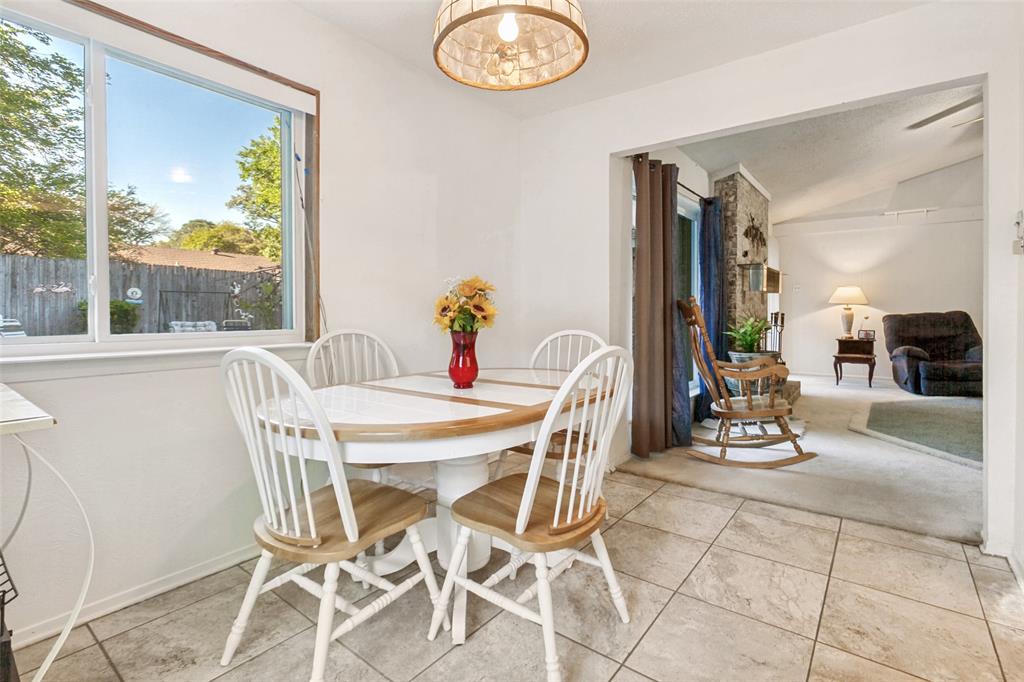 44 Merrie Circle Richardson, TX 75081 - Photo 15 of 30 a view of a dining room with furniture a chandelier and wooden floor