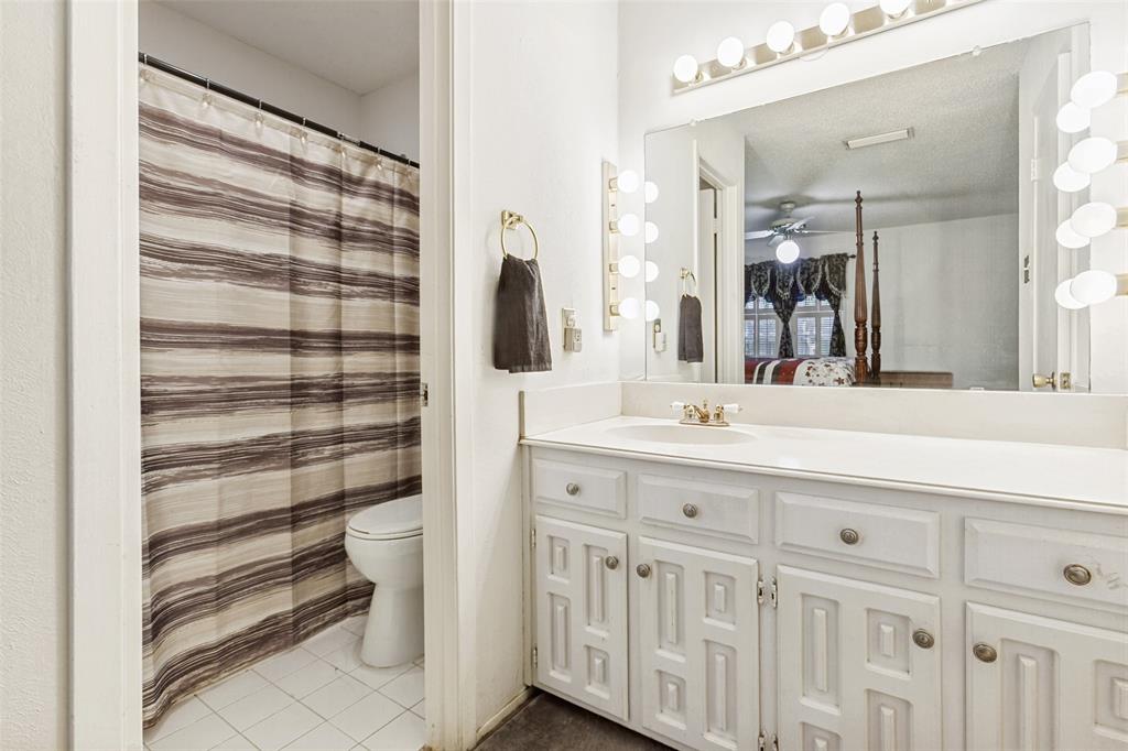 44 Merrie Circle Richardson, TX 75081 - Photo 17 of 30 a bathroom with a double vanity sink a mirror a bathtub and shower