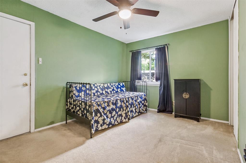 44 Merrie Circle Richardson, TX 75081 - Photo 18 of 30 a bed room with a bed and a chandelier