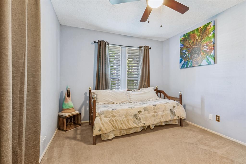 44 Merrie Circle Richardson, TX 75081 - Photo 20 of 30 a bedroom with a bed and a painting on the wall