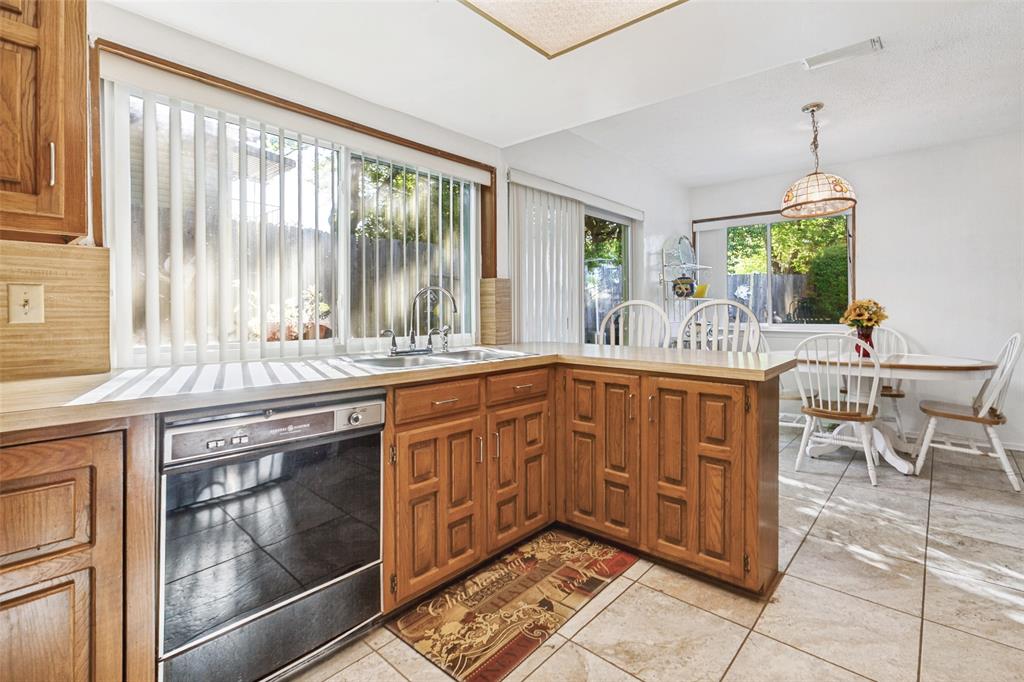 44 Merrie Circle Richardson, TX 75081 - Photo 10 of 30 a kitchen with stainless steel appliances granite countertop a stove a sink and a microwave