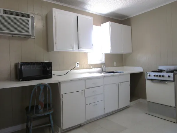 a kitchen with stainless steel appliances a sink stove and microwave