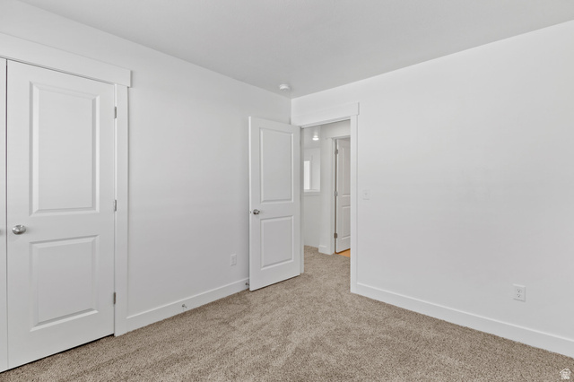 1269 West 500 South Logan, UT 84321 - Photo 16 of 19 Neutral-toned carpet flooring complements white walls with white trim and baseboards