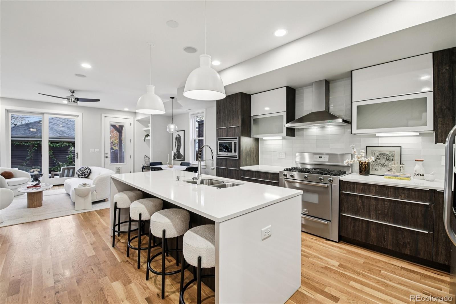 2825 Stout Street Denver, CO 80205 - Photo 11 of 42 a kitchen with stainless steel appliances a sink stove and wooden floor
