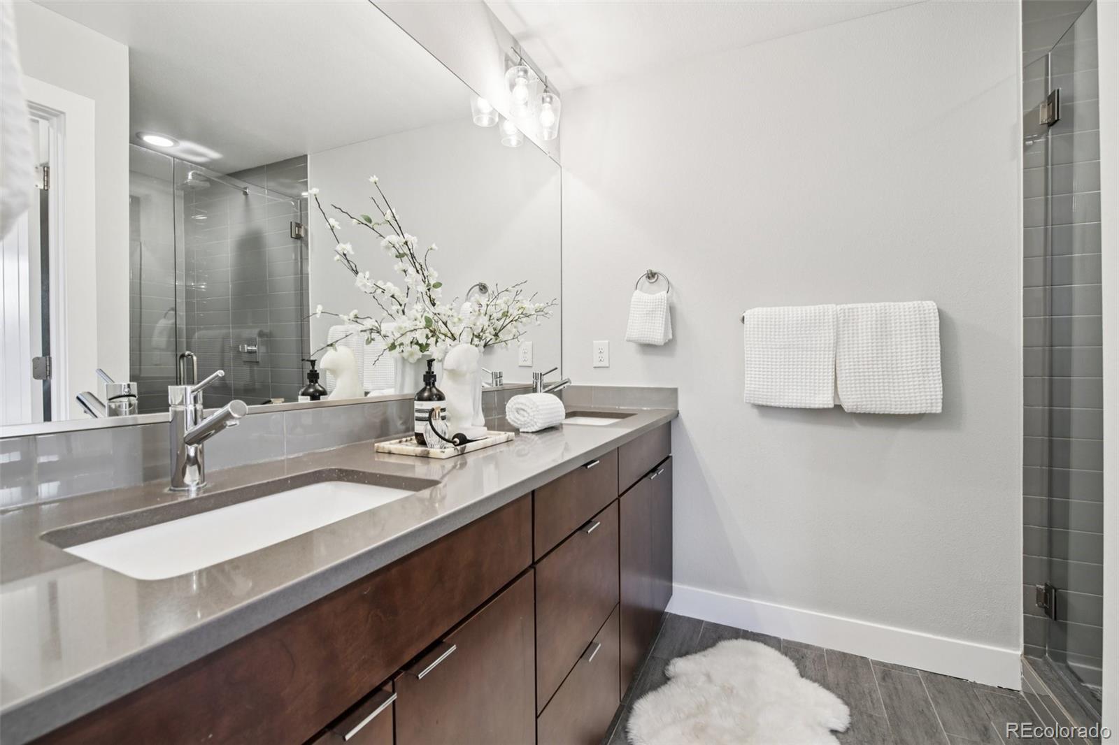 2825 Stout Street Denver, CO 80205 - Photo 19 of 42 a bathroom with a sink and a mirror