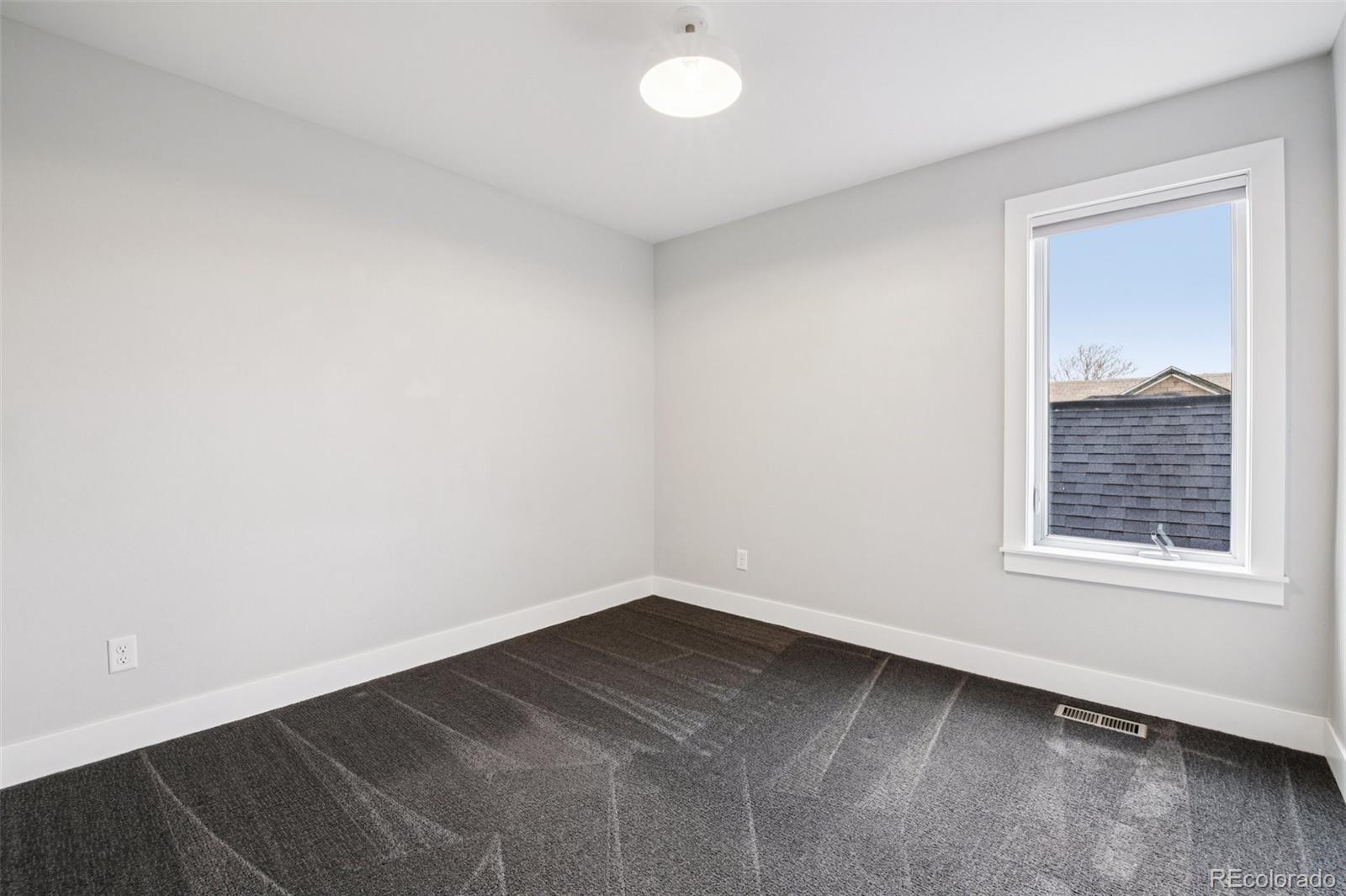 2825 Stout Street Denver, CO 80205 - Photo 22 of 42 an empty room with a window