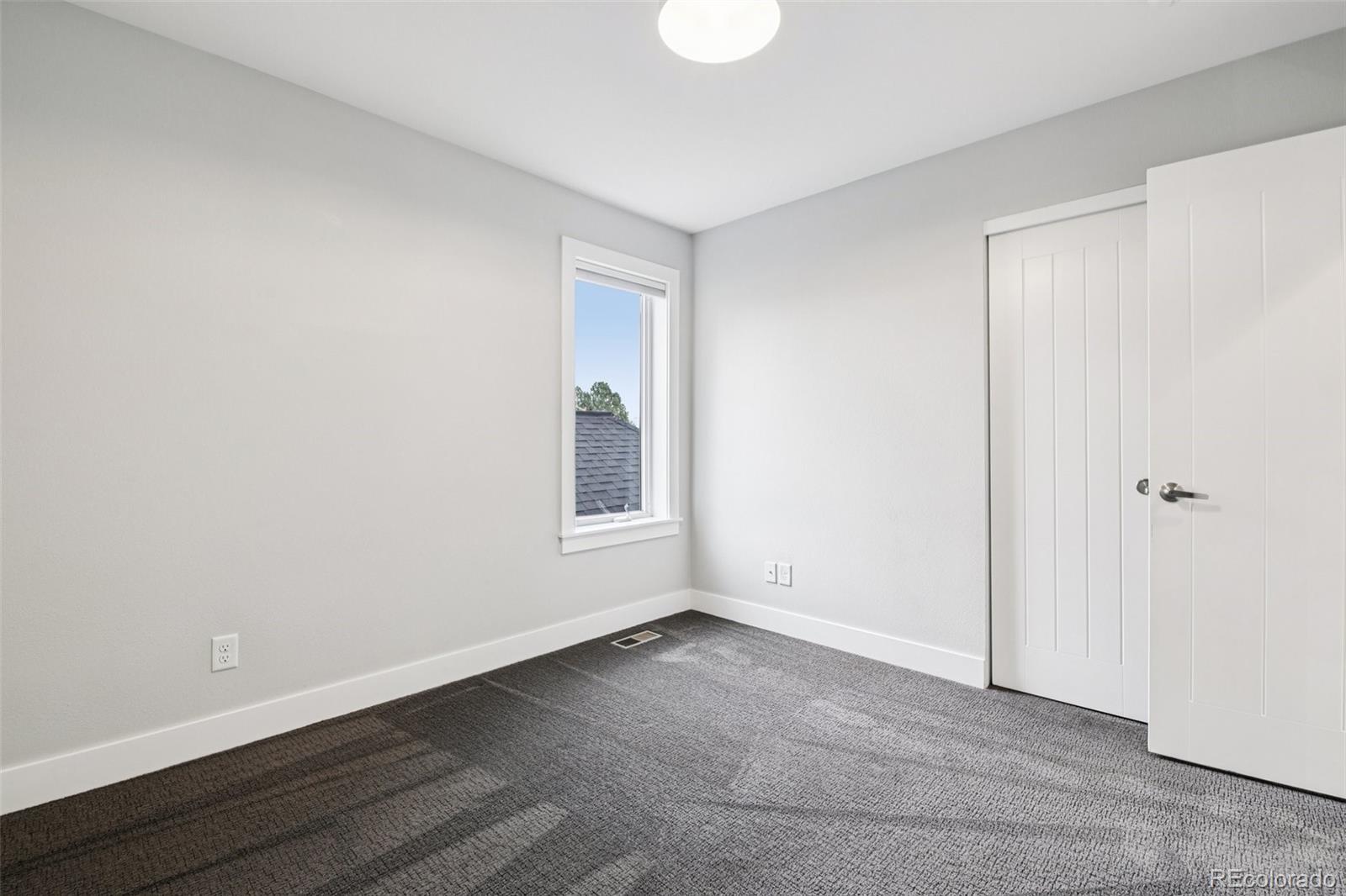 2825 Stout Street Denver, CO 80205 - Photo 23 of 42 a view of an empty room with a window