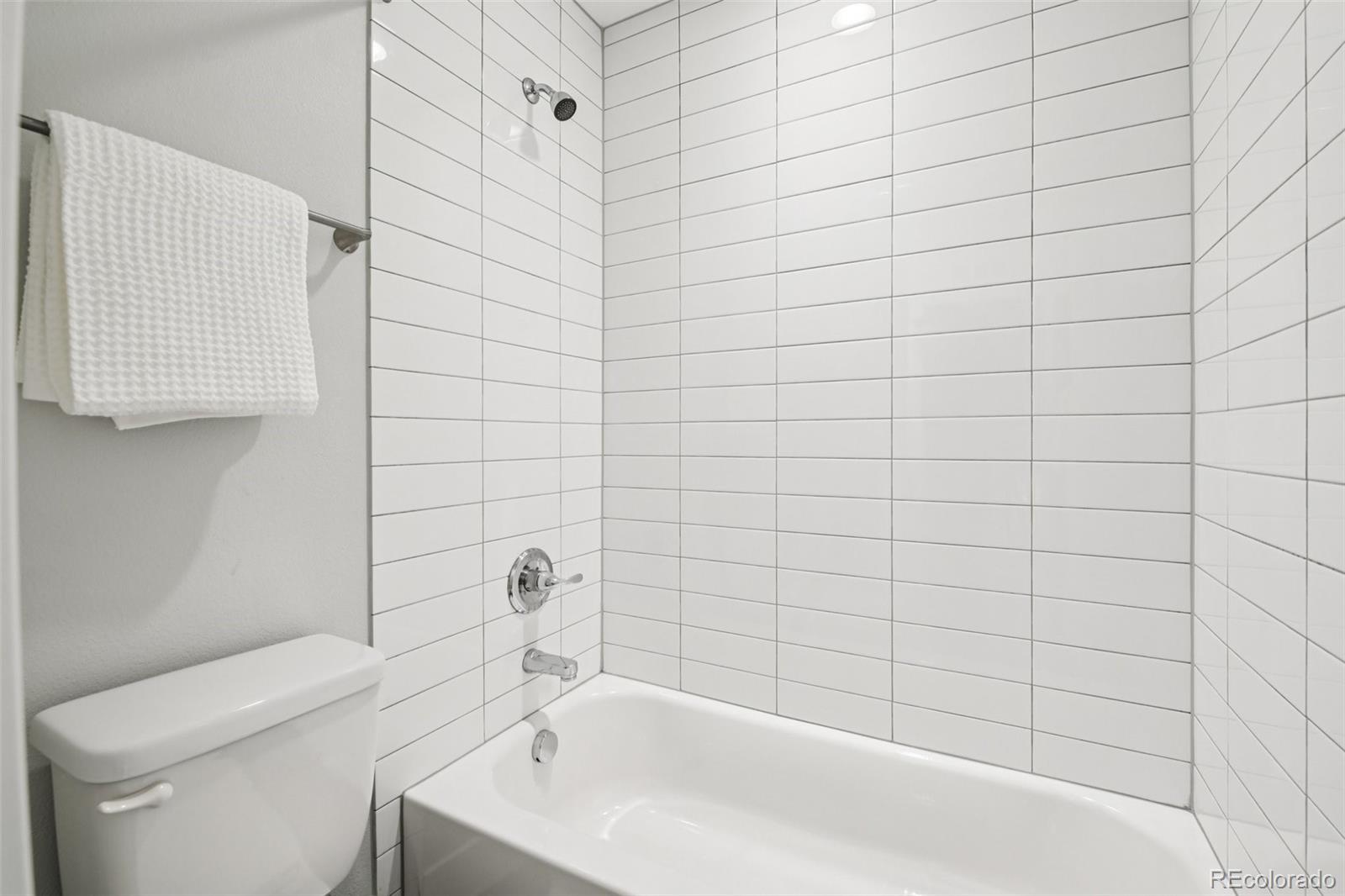 2825 Stout Street Denver, CO 80205 - Photo 25 of 42 a bathroom with a bathtub and shower