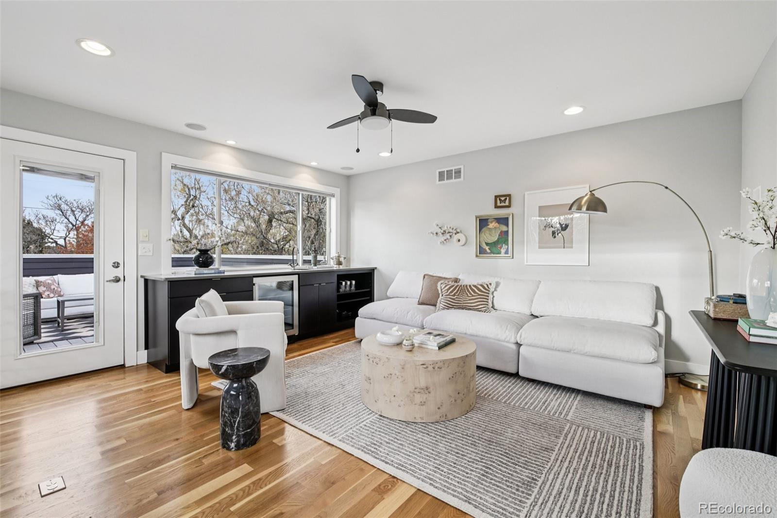 2825 Stout Street Denver, CO 80205 - Photo 27 of 42 a living room with furniture and a painting on the wall
