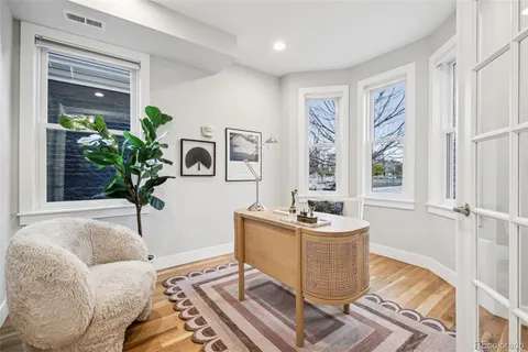 a living room with furniture and kitchen view