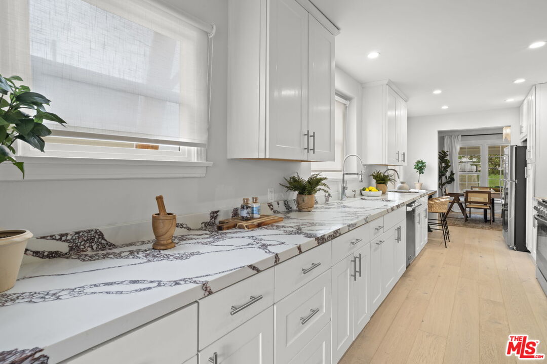 9325 Oakmore Road Los Angeles, CA 90035 - Photo 13 of 46 a kitchen with sink and cabinets