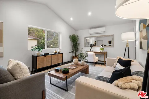 a living room with furniture or couch and a large window