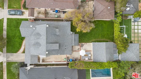 an aerial view of a house with a yard